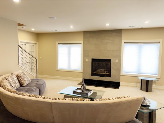 carpeted living room featuring a tile fireplace, baseboards, and recessed lighting