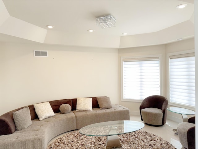 living area with recessed lighting, visible vents, and baseboards
