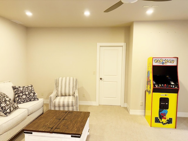 living room with ceiling fan, baseboards, recessed lighting, and light colored carpet