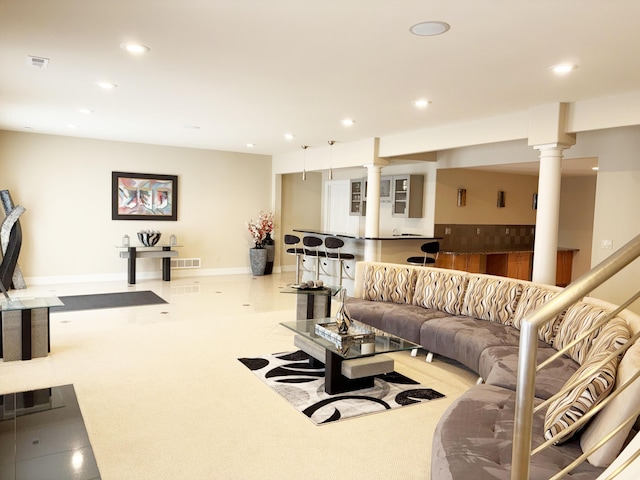 living area with visible vents, recessed lighting, and ornate columns