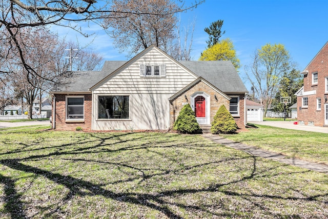 view of front of property with a shingled roof, a front lawn, concrete driveway, brick siding, and a garage