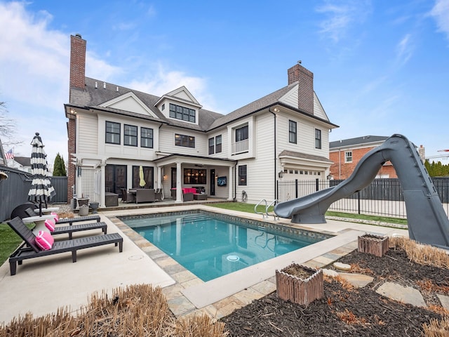 457 Catalpa Dr, Birmingham, MI 48009 - rear view of house featuring fence, an outdoor living space, a chimney, a patio, and a garage