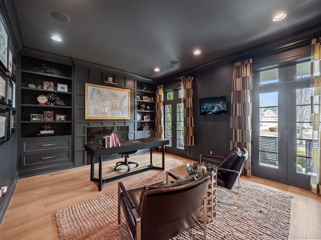 home office featuring crown molding, french doors, and a healthy amount of sunlight