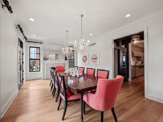 457 Catalpa Dr, Birmingham, MI 48009 - dining space with a chandelier, light wood finished floors, ornamental molding, recessed lighting, and baseboards