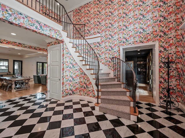 stairs featuring recessed lighting, wallpapered walls, baseboards, and ornamental molding