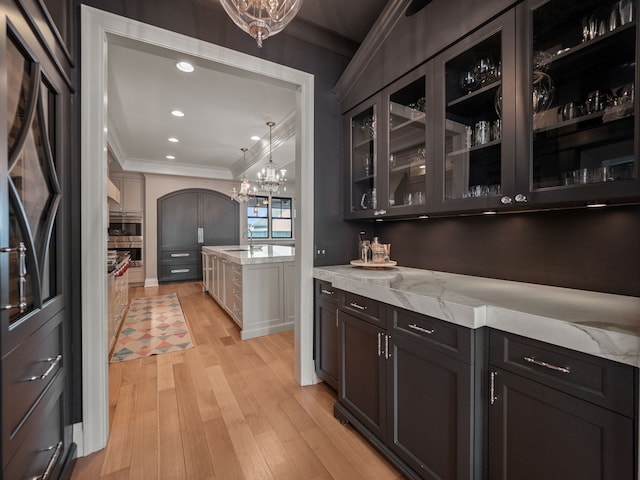 457 Catalpa Dr, Birmingham, MI 48009 - bar area featuring ornamental molding, light wood finished floors, a sink, a chandelier, and black refrigerator