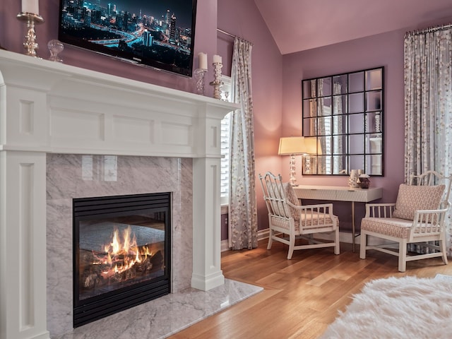 457 Catalpa Dr, Birmingham, MI 48009 - sitting room featuring a premium fireplace, wood finished floors, lofted ceiling, and baseboards