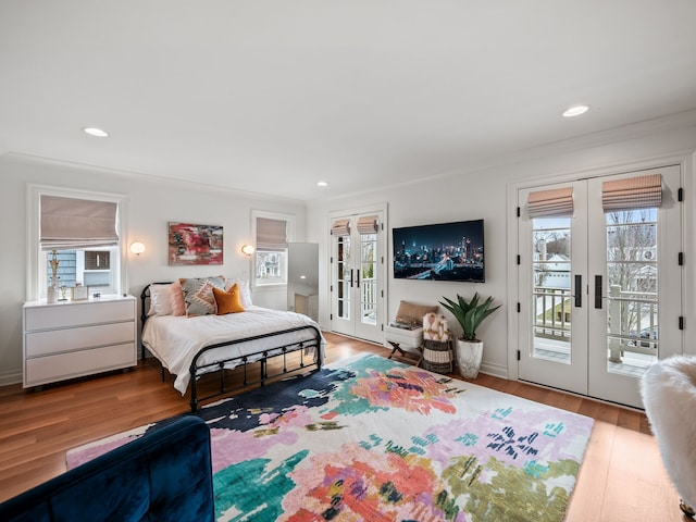 bedroom with french doors, wood finished floors, recessed lighting, and access to exterior