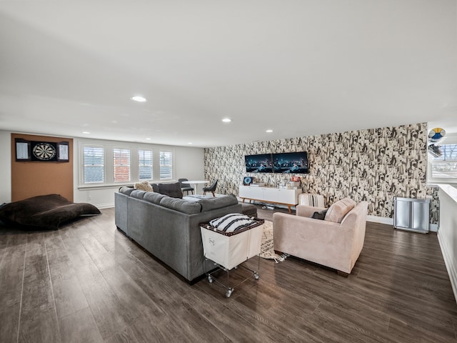 living room featuring recessed lighting, baseboards, a wealth of natural light, and dark wood-style floors