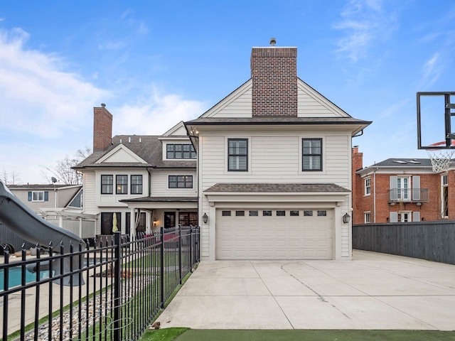 457 Catalpa Dr, Birmingham, MI 48009 - view of front facade with an attached garage, driveway, fence, and a chimney