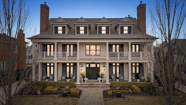 457 Catalpa Dr, Birmingham, MI 48009 - view of front of home featuring french doors, a chimney, a balcony, and a shingled roof