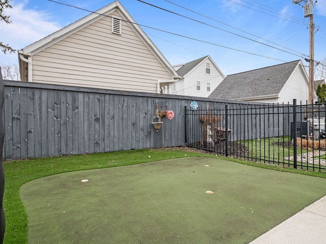 457 Catalpa Dr, Birmingham, MI 48009 - view of yard with a putting area and fence