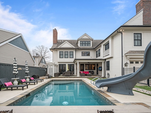 457 Catalpa Dr, Birmingham, MI 48009 - view of swimming pool with a water slide, outdoor lounge area, fence, and a patio area