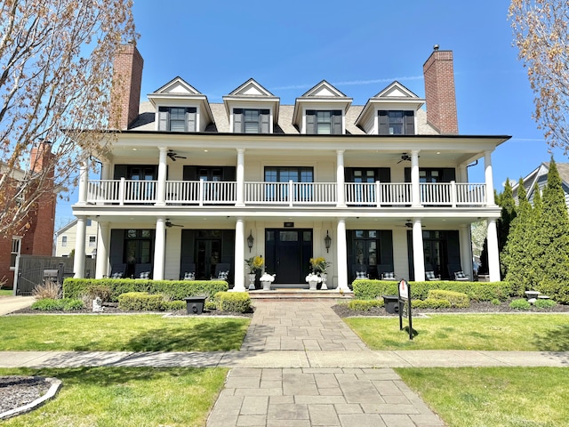 457 Catalpa Dr, Birmingham, MI 48009 - view of front of property featuring ceiling fan, a chimney, a balcony, and a front lawn