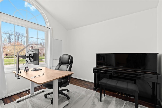office area featuring baseboards, wood finished floors, and lofted ceiling