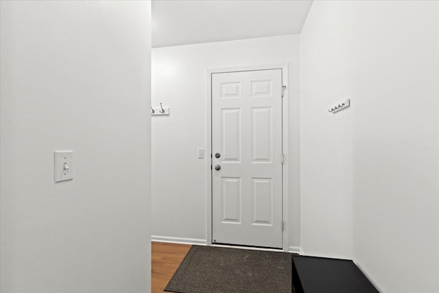 entryway with baseboards and wood finished floors