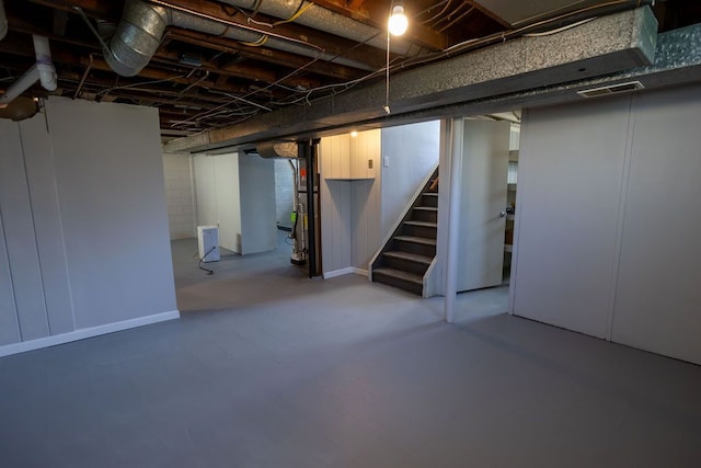 basement featuring visible vents and stairs
