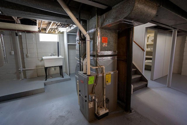 below grade area featuring stairway, heating unit, and a sink