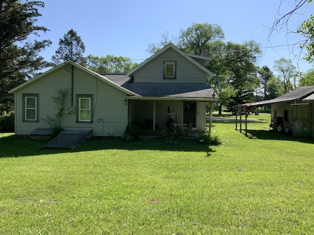 back of property featuring a lawn, a porch, and a chimney