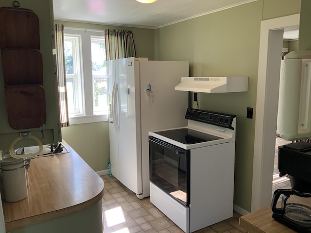kitchen featuring baseboards, range with electric stovetop, light countertops, under cabinet range hood, and ornamental molding