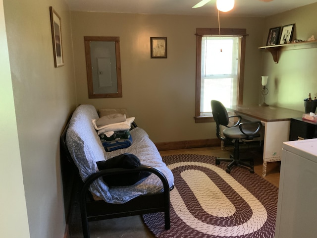 office space with a ceiling fan and electric panel