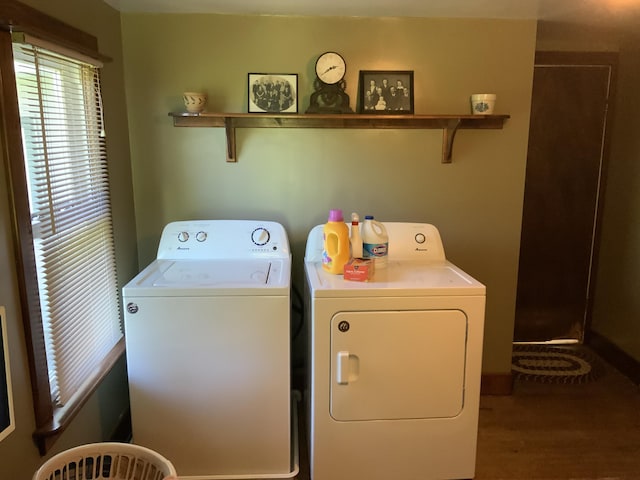 washroom with washer and dryer, wood finished floors, and laundry area