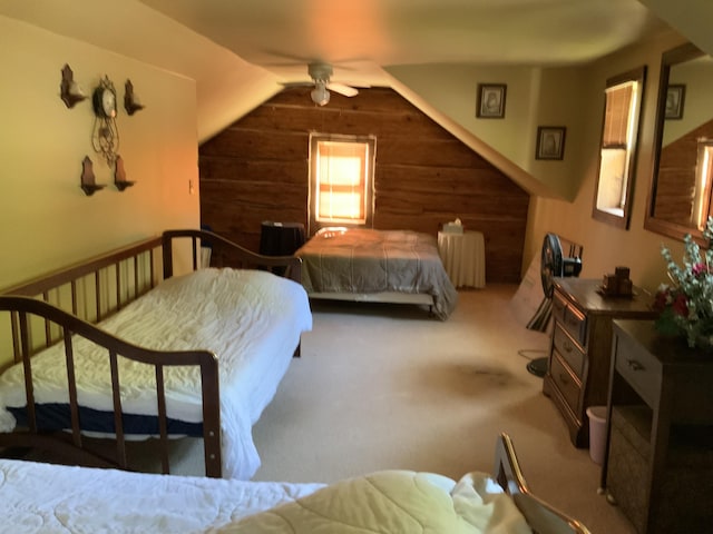bedroom featuring vaulted ceiling, carpet flooring, and wood walls