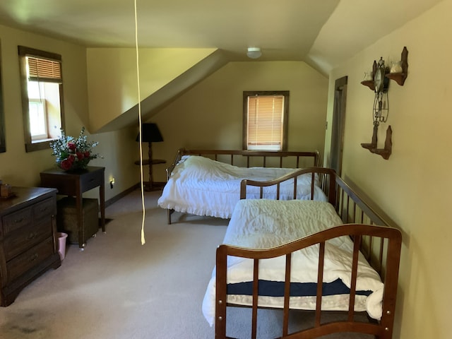 bedroom featuring lofted ceiling and carpet
