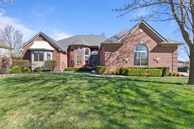 single story home featuring a front lawn and brick siding