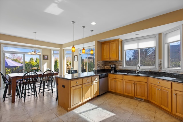 kitchen with dishwasher, a healthy amount of sunlight, and a sink