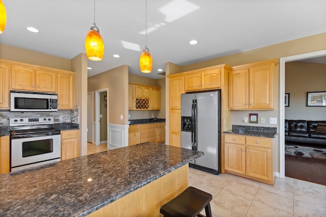 kitchen featuring recessed lighting, decorative light fixtures, decorative backsplash, and stainless steel appliances