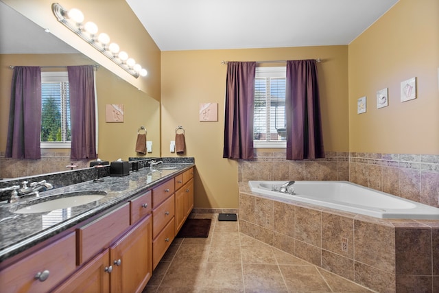 full bathroom featuring tile patterned floors, a garden tub, a sink, and a healthy amount of sunlight
