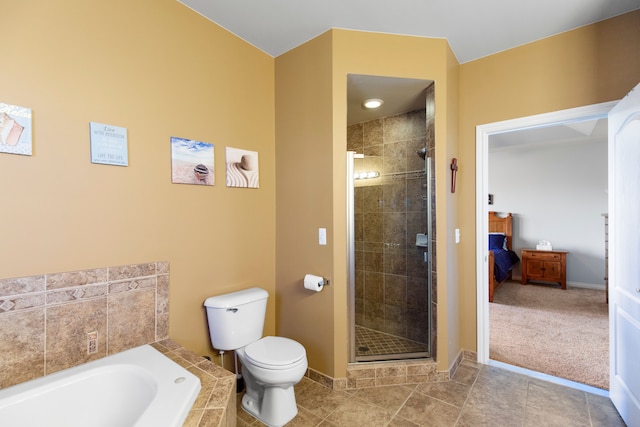 bathroom featuring a bath, a shower stall, toilet, and baseboards