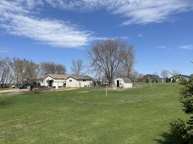 view of yard featuring an outbuilding and a shed