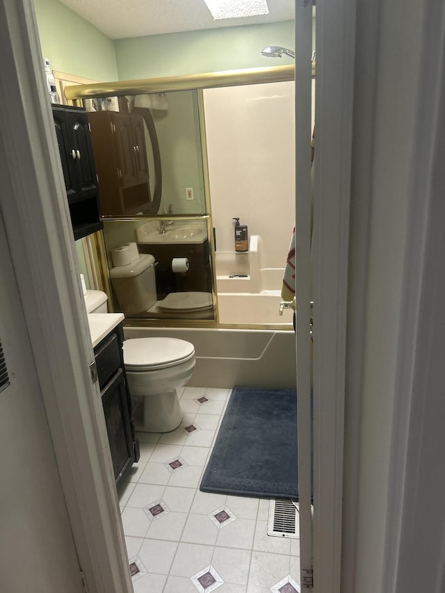 bathroom featuring shower / bath combination, tile patterned flooring, vanity, and toilet