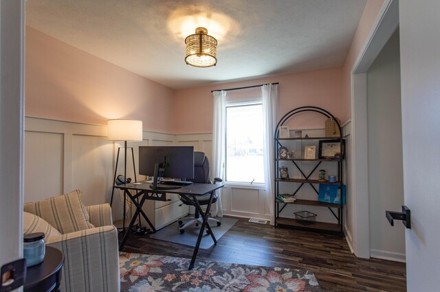 333 Quarterline St, Newaygo, MI 49337 - office area with wainscoting, visible vents, dark wood-type flooring, and a decorative wall
