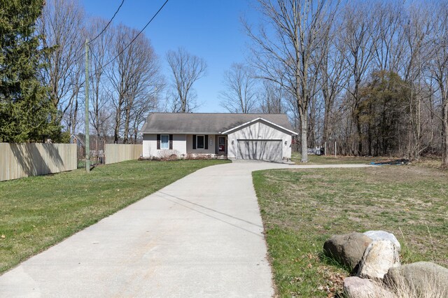 333 Quarterline St, Newaygo, MI 49337 - ranch-style home featuring fence, an attached garage, a front yard, and concrete driveway