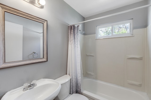 full bath with a sink, shower / tub combo, and toilet