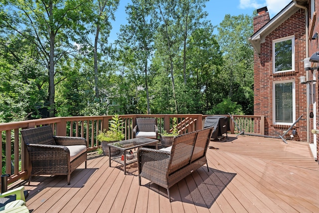 wooden deck with an outdoor living space