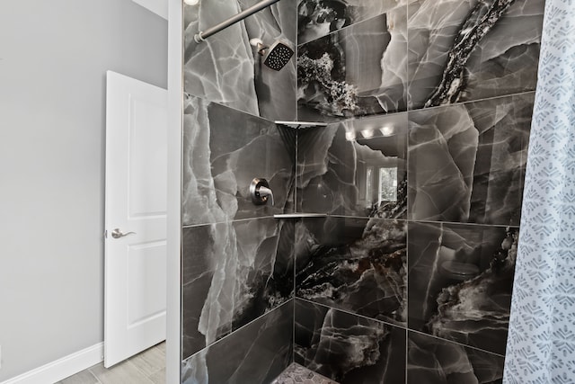 bathroom with tiled shower