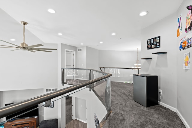 corridor featuring baseboards, an upstairs landing, visible vents, and recessed lighting