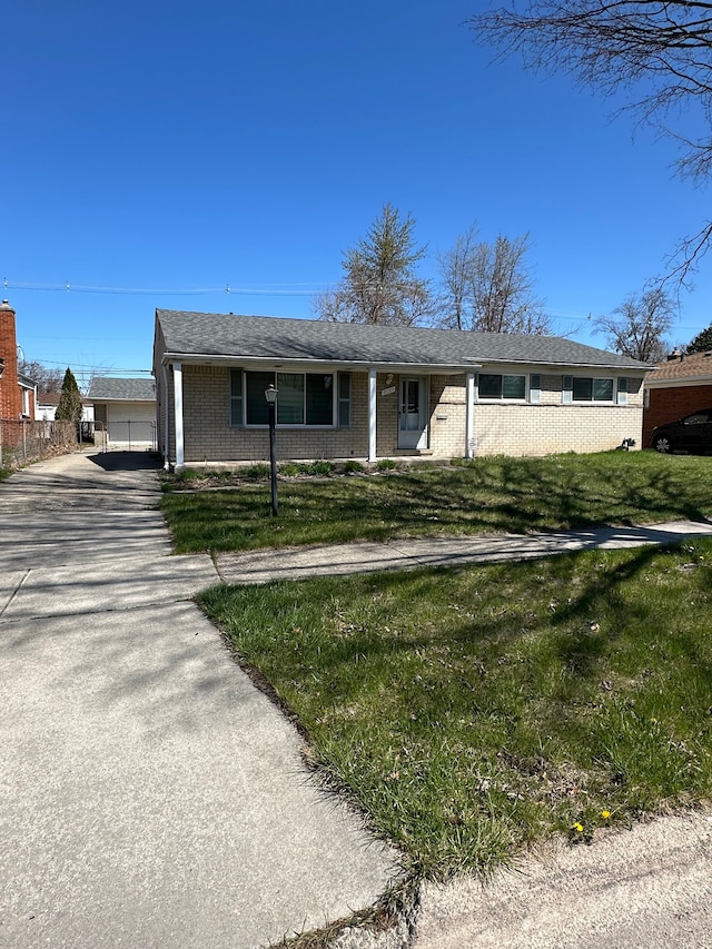 ranch-style house with brick siding and a front yard