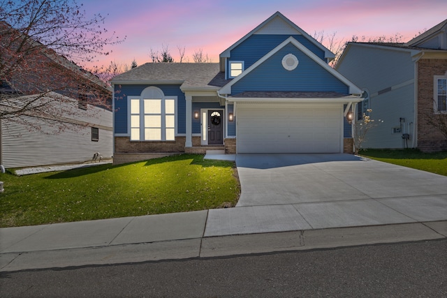 view of front facade featuring a lawn, concrete driveway, brick siding, and a garage