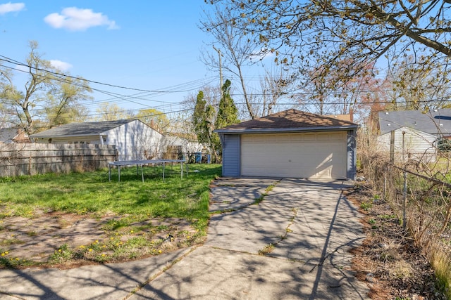 26488 Stollman Dr, Inkster, MI 48141 - detached garage featuring fence and a trampoline