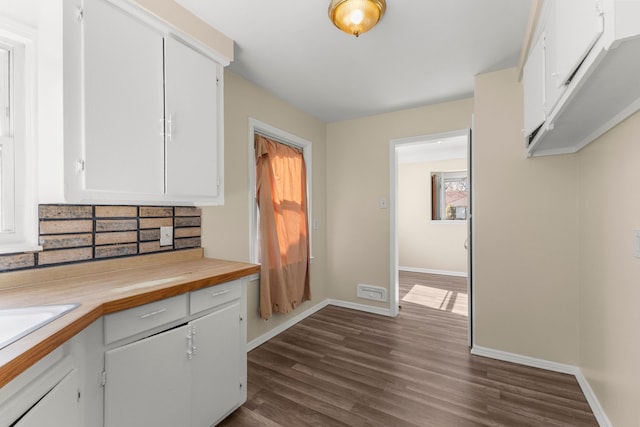 26488 Stollman Dr, Inkster, MI 48141 - kitchen featuring white cabinets, baseboards, and dark wood-style floors