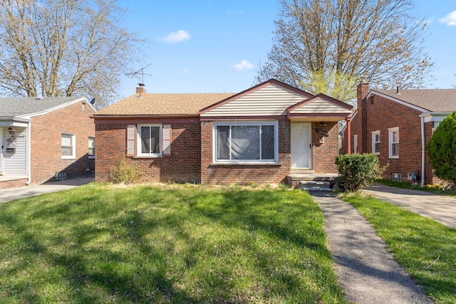 26488 Stollman Dr, Inkster, MI 48141 - bungalow-style home with brick siding, a chimney, and a front lawn