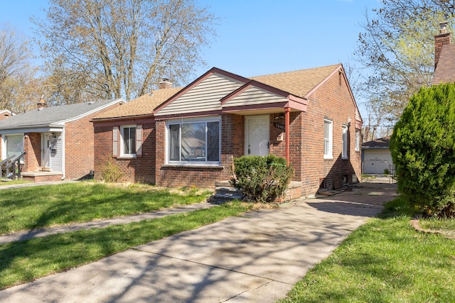 26488 Stollman Dr, Inkster, MI 48141 - view of front of home with a chimney, a shingled roof, an outdoor structure, brick siding, and a front yard