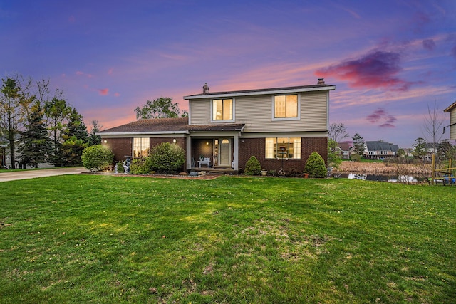 92 Brookfield Dr, Oxford, MI 48371 - traditional-style home featuring brick siding, a front yard, a chimney, and a porch