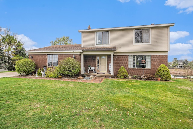 92 Brookfield Dr, Oxford, MI 48371 - traditional-style house with brick siding, a front yard, and a chimney