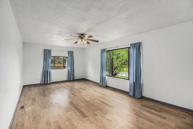92 Brookfield Dr, Oxford, MI 48371 - empty room featuring wood finished floors, a ceiling fan, baseboards, and a textured ceiling